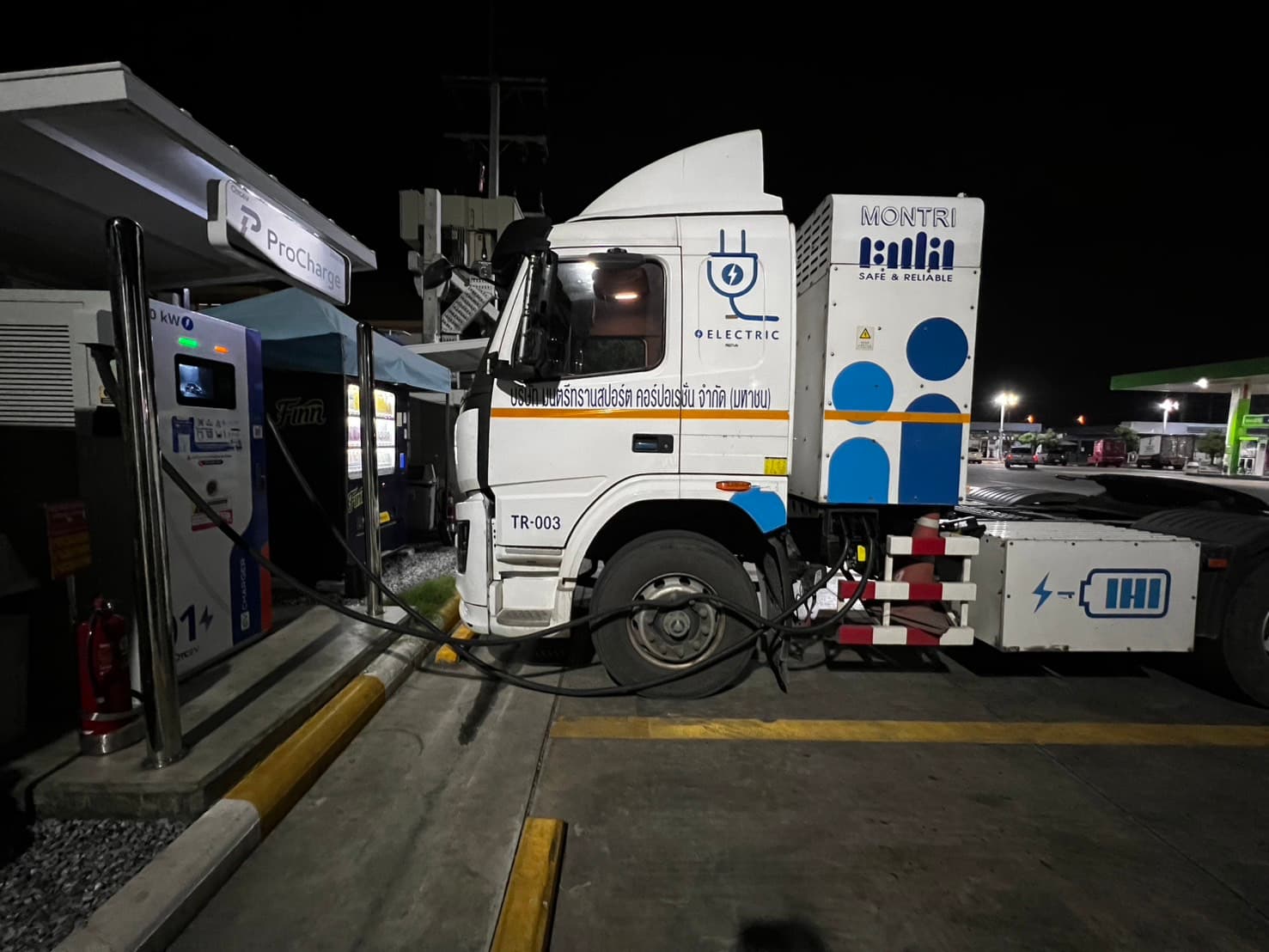 A ProCharge charger charging a MONTRI electric truck at night